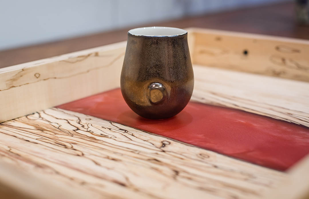 Gold ceramic cup by Lisa Gluckin.