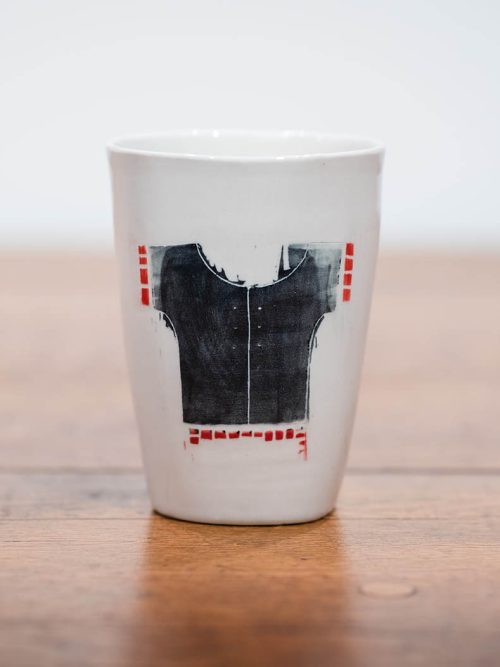 Large ceramic cup by Lisa Gluckin featuring a shirt.