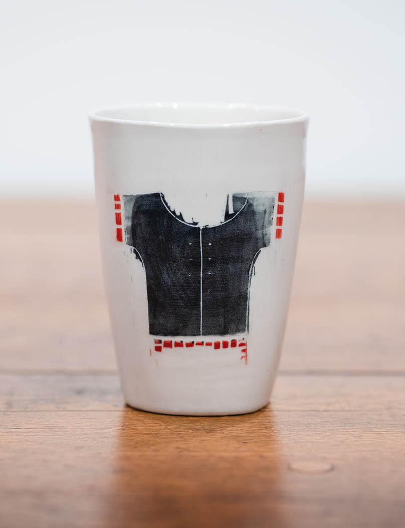 Large ceramic cup by Lisa Gluckin featuring a shirt.