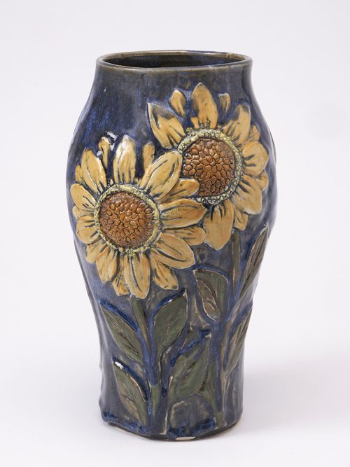 A ceramic sunflower vase by Hog Hill Pottery.
