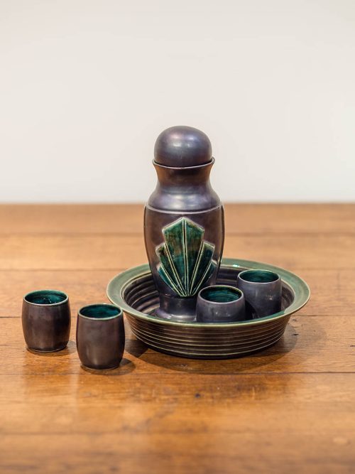 Ceramic whiskey set with a pewter finish by artist Leslie Green Guilbault.