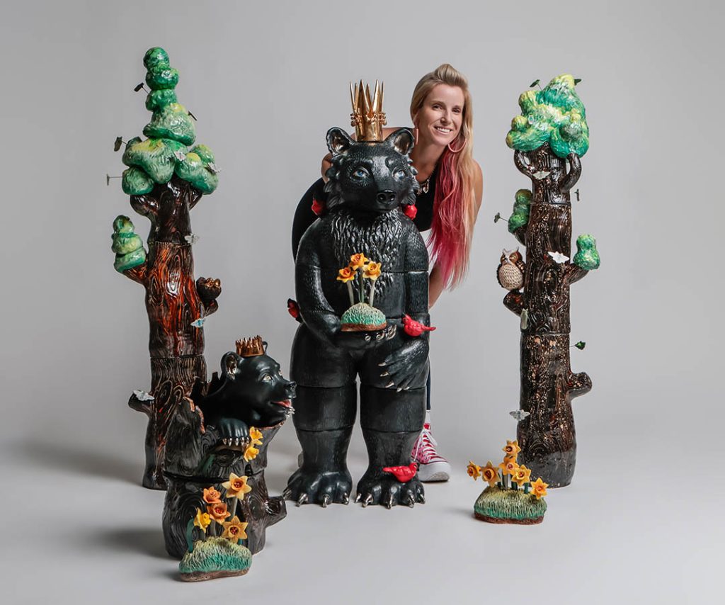 Artist Taylor Robenalt posed with her sculpture titled “Mama Bear and Cub Rising with Resilience”