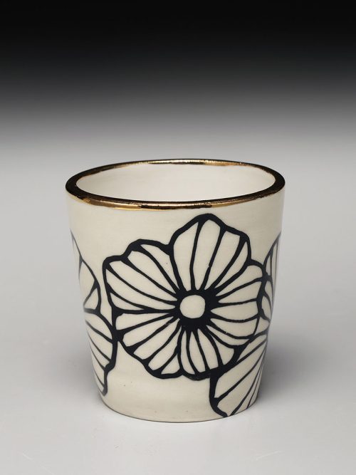 Handcrafted stoneware tumbler by Nicole Hsieh featuring a bold black-and-white floral motif inspired by vintage pottery and textiles.