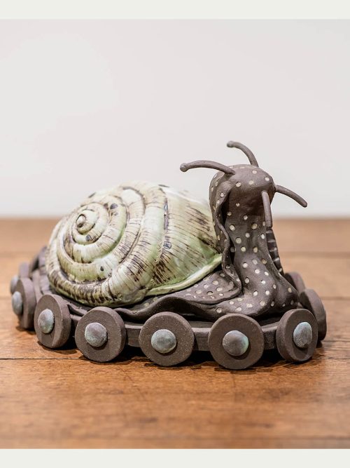 Ceramic snail sculpture titled Slow To Go by artist Libba Tracy.