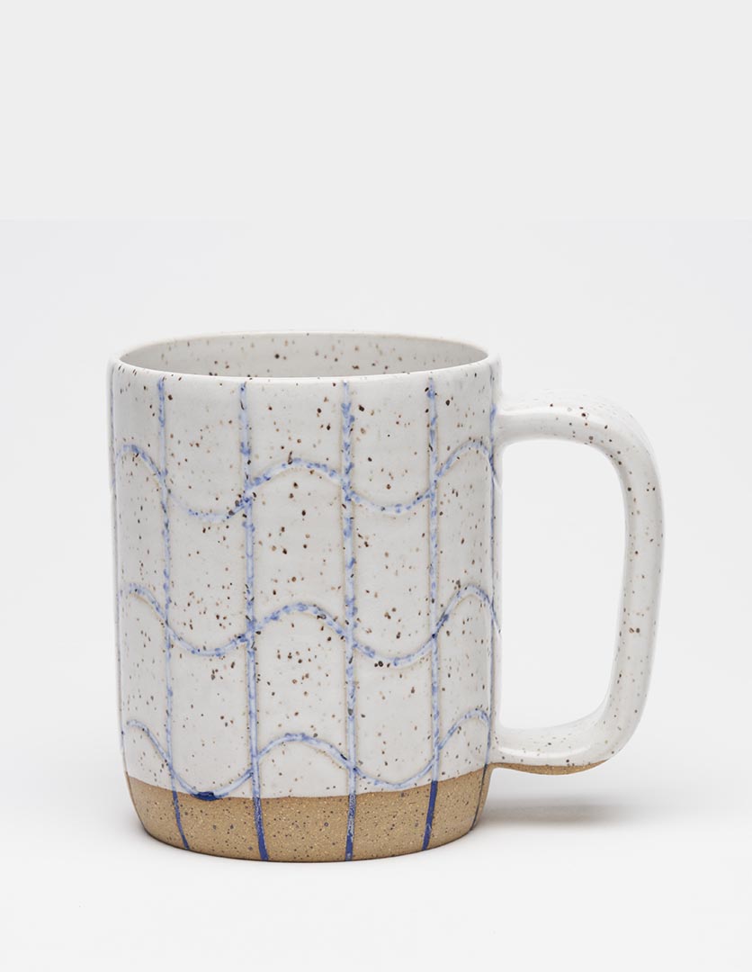 The Osso Ceramics "Poolside" mug is a handcrafted, wheel-thrown stoneware mug featuring a distinctive hand-carved grid pattern with straight vertical lines and a wavy, squiggle design.