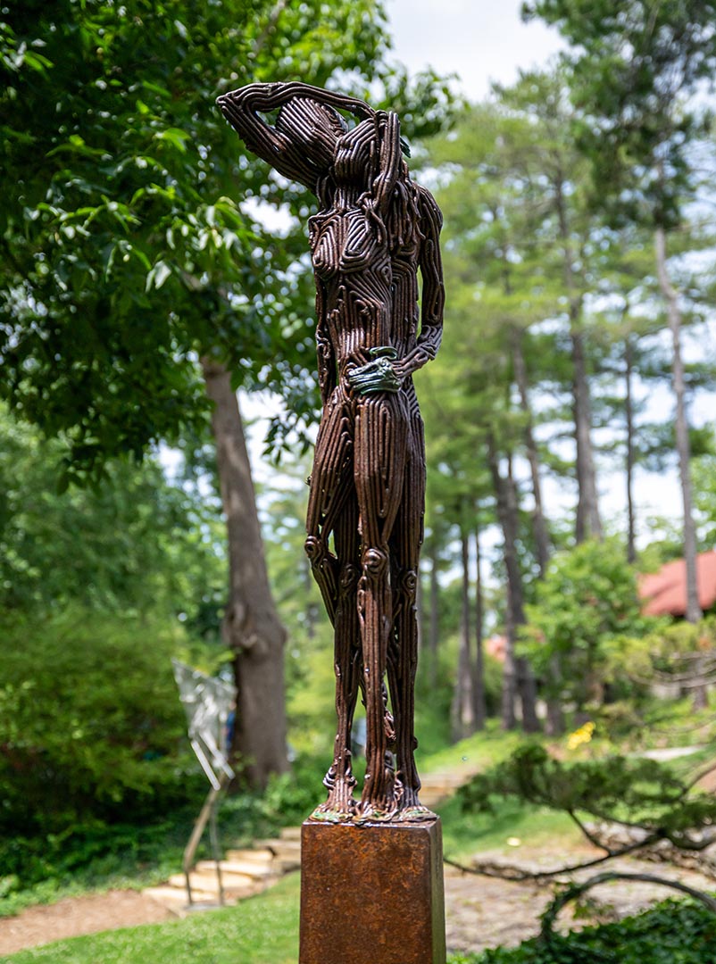 An outdoor sculpture of two figures by artist J. Aaron Alderman titled Like a Memory.