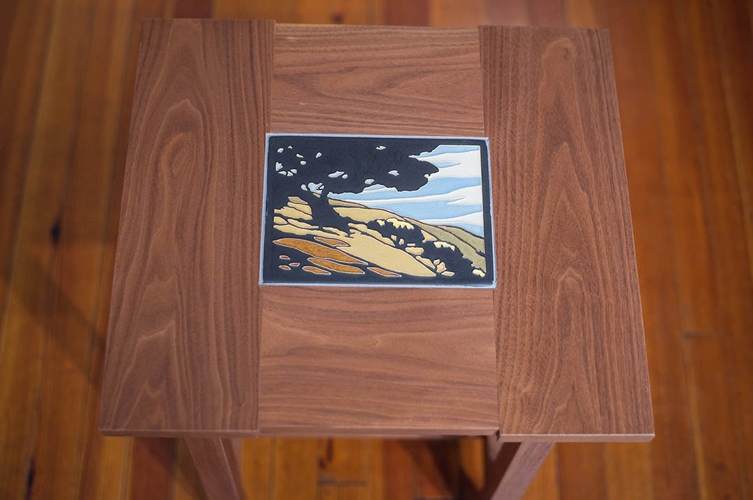 A walnut table handcrafted by artist Tim Livingston with a Motawi tile insert.