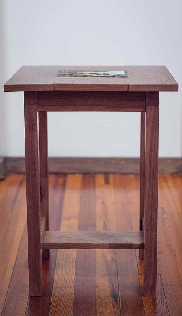A walnut table handcrafted by artist Tim Livingston with a Motawi tile insert.