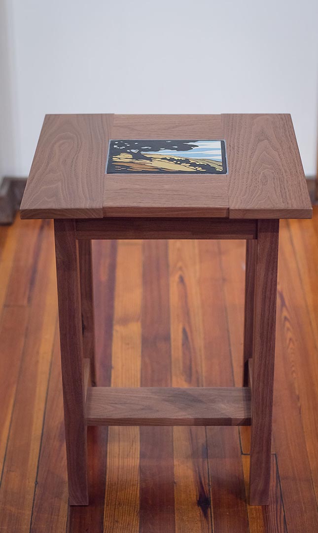 A walnut table handcrafted by artist Tim Livingston with a Motawi tile insert.